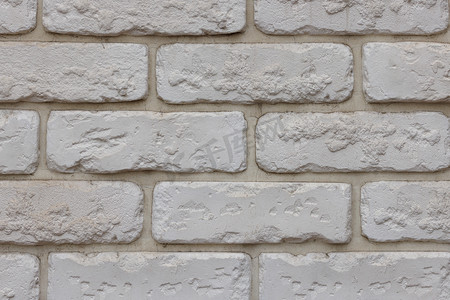 嵌缝摄影照片_假白砖墙，仿天然砖砌的塑料面板