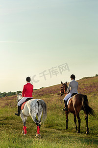 两个年轻女子在公园里骑马。