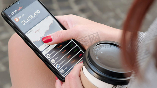 喝咖啡的小女孩分析比特币的价格，并在智能手机的移动应用程序中购买比特币。带有移动应用程序钱包加密货币的智能手机。