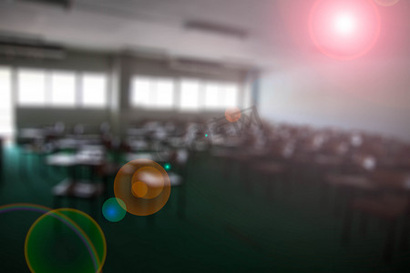 绿色会议背景板摄影照片_大教室里的椅子模糊镜头光晕背景