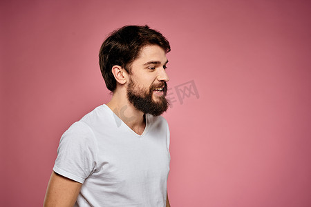 穿着白色 T 恤的男人情绪生活方式面部表情裁剪视图粉红色背景。