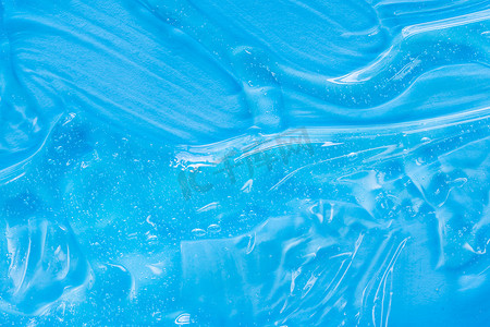 透明蓝色底摄影照片_.蓝色化妆品凝胶质地与气泡。