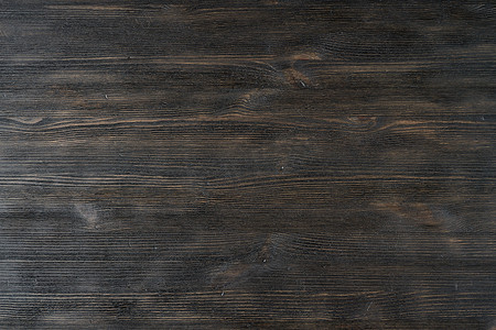 棕色木纹摄影照片_深黑棕色纹理木质背景图案。
