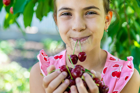 一个孩子在花园里采摘樱桃。