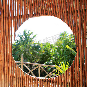 木棍小屋热带丛林中的圆形窗户