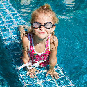 孩子游泳摄影照片_泳池里的小女孩