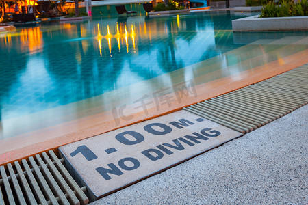 动物警示牌摄影照片_豪华酒店泳池设有“1.00m禁止潜水”警示牌