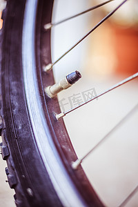 胎压摄影照片_城市中的自行车：轮胎出口和辐条的特写图片