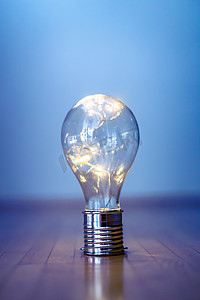 想法和创新：带 LED 的灯泡躺在木地板上。