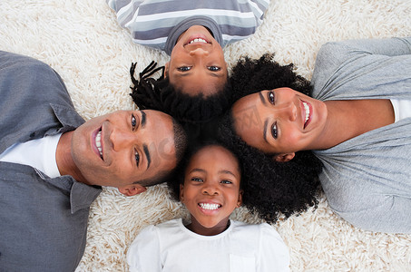 靠在一起摄影照片_非裔美国家庭在地板上头靠在一起