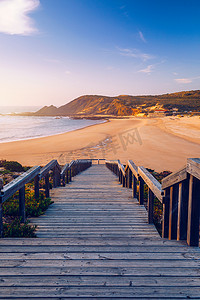 草原旅游摄影照片_通往葡萄牙阿尔加维阿尔热祖尔区 Praia da Amoreira 海滩的木制走道。