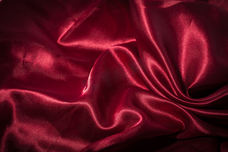折叠衣服摄影照片_红色丝绸纺织背景