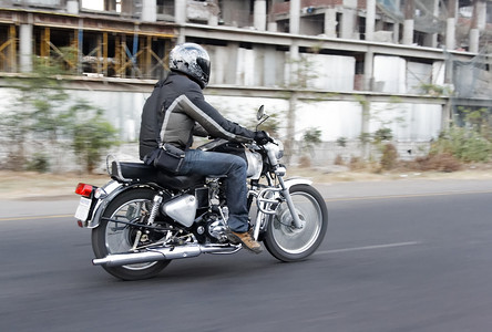 印度工厂摄影照片_在印度老工厂附近骑摩托车进行