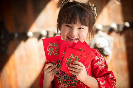 新年到字摄影照片_可爱的小女孩拿着红包