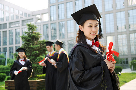 读书活动摄影照片_四个身穿学士服的大学生