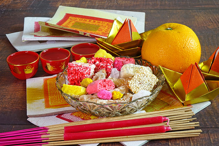 女神神摄影照片_一套五彩缤纷的小吃、橙子、茶、蜡烛、香棍和香纸，在中国的所有文化节中都是献给道教神、女神和祖先的。复制空间