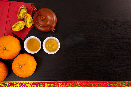 orange摄影照片_Flat lay Chinese new year mandarin orange and tea water with top view Copy space  for celebrate china festival.hinese characters ZHAO CAI JIN BAO in the article refer to lucky fortune ,wealth, rich