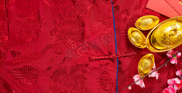 Chinese new year festival with home decoration and gold ingots on a blue color satin blanket .Chinese characters ZHAO CAI JIN BAO in the article refer to lucky fortune ,wealth, rich and money flow