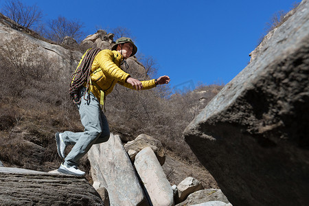 登山徒步的人摄影照片_徒步旅行的青年男人