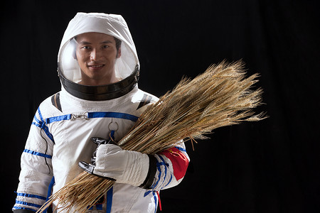 麦子特写摄影照片_宇航员抱着麦子