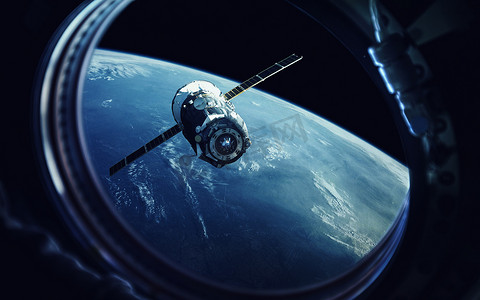 展板元素摄影照片_从宇宙飞船的港口看。地球和航天器。这张图片的元素由美国宇航局提供