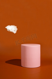 product platform arrangement in pink pastel color decorated with cotton as clouds. trendy display layout with an empty podium for showcasing cosmetics, skincare, or other products.