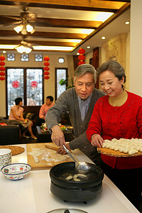 过年包饺子摄影照片_中国老年夫妇包饺子