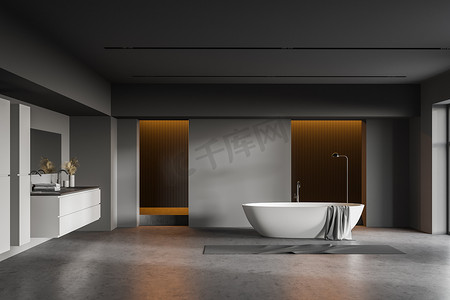 渲染台面摄影照片_设有深灰色墙壁、混凝土地面、舒适浴缸的宽敞浴室内部，以及带有水平镜的灰色台面双层水池。3d渲染
