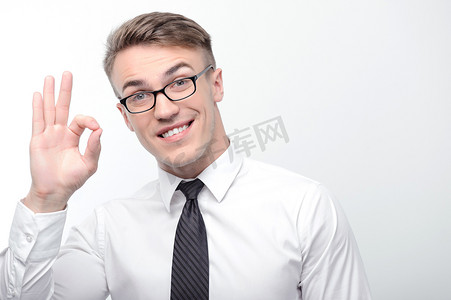 Smiling businessman pointing ok with his fingers