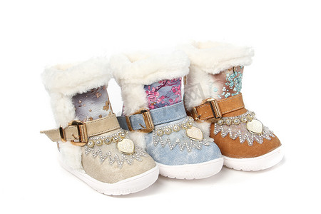 冬季女靴主图摄影照片_冬季靴的鞋的孩子在白色背景