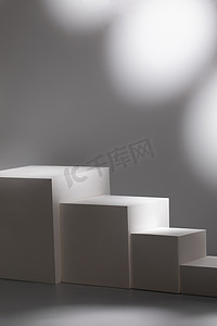 scene with four square podiums on gray background