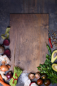 vegetable摄影照片_Healthy food background on wooden board. Vegetable menu. Top view, copy space.