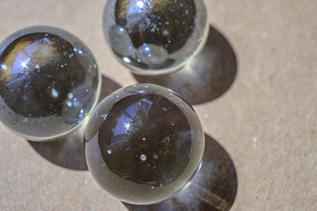 three shiny glass balls on recycled paper