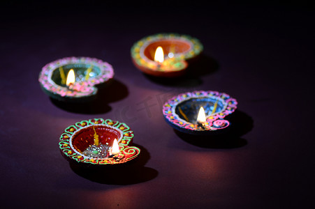 Colorful clay Diya (Lantern) lamps lit during Diwali celebration. Greetings Card Design Indian Hindu Light Festival called Diwali.