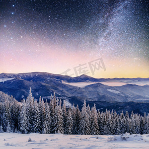 在冬雪的夜空中繁星闪烁。梦幻般的银河在除夕夜。期待假期的到来。戏剧性的场面。喀尔巴阡山.乌克兰.