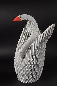 日本模块折纸。白纸天鹅在黑色背景下.创意技能艺术爱好。有选择的重点
