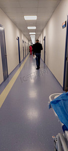 abstract unfocused blurred background of technological space, Medical and hospital corridor with a defocused background with a modern hospital. People walk and wait for the doctor near the door.