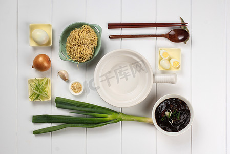 Food Knolling Asian Noodle, Flat Lay Concept Ingredients of Jajangmyeon or Jjajangmyeon, Korean Noodle with Black Bean Sauce. On White Wooden Background 