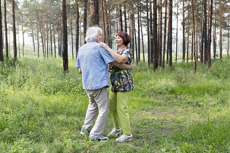 年长的夫妇，在夏天的森林里跳舞