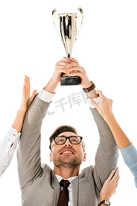 成功的商人拿着奖杯杯以上的头, 而同事试图让它孤立在白色