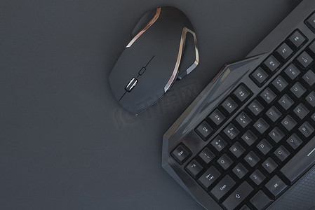 黑色鼠标, 键盘上隔离的暗背景, 顶部视图。平躺玩家的背景。在黑色背景上使用键盘和鼠标的工作区。Copyspace