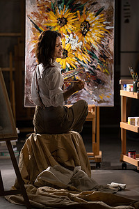 美术室边框摄影照片_年轻的女画家在工作室绘画