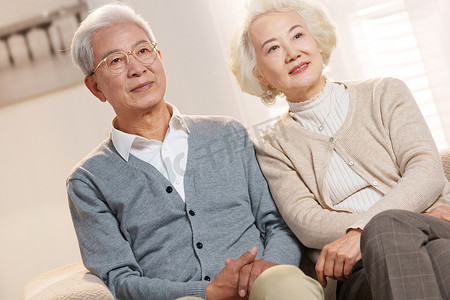 温馨舒适的家摄影照片_幸福的老年夫妇坐在沙发上