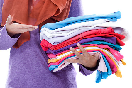 hands presenting clean and tidy folded clothes after ironing
