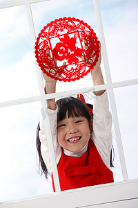 可爱背景春节摄影照片_小女孩贴窗花