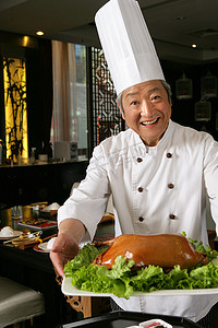 酥不腻烤鸭摄影照片_中国厨师和烤鸭