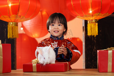 小清新小元素摄影照片_可爱的小男孩收到新年礼物小兔子