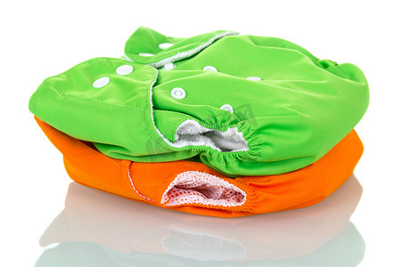 Green and orange modern eco friendly diapers isolated on white.