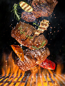 牛排火锅摄影照片_火锅烧烤炉, 铸铁炉排, 美味的牛排在空中飞翔.