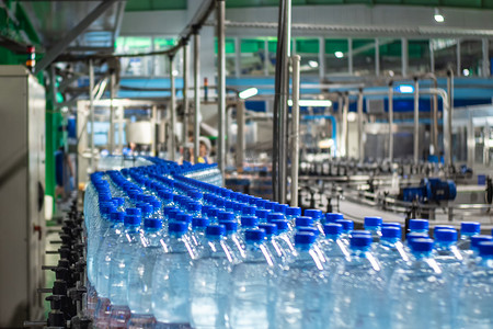矿泉水厂的蓝塑料瓶分三排装着干净饮用水的传送带。粮食生产